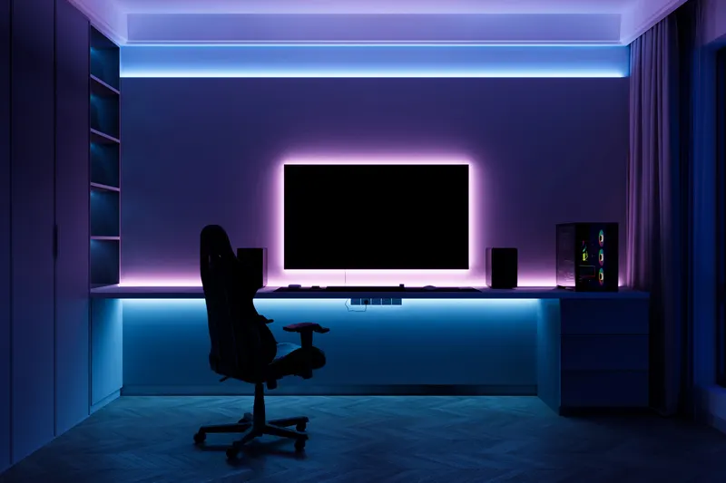 A dark gaming-style room with a single large monitor and neon lighting.